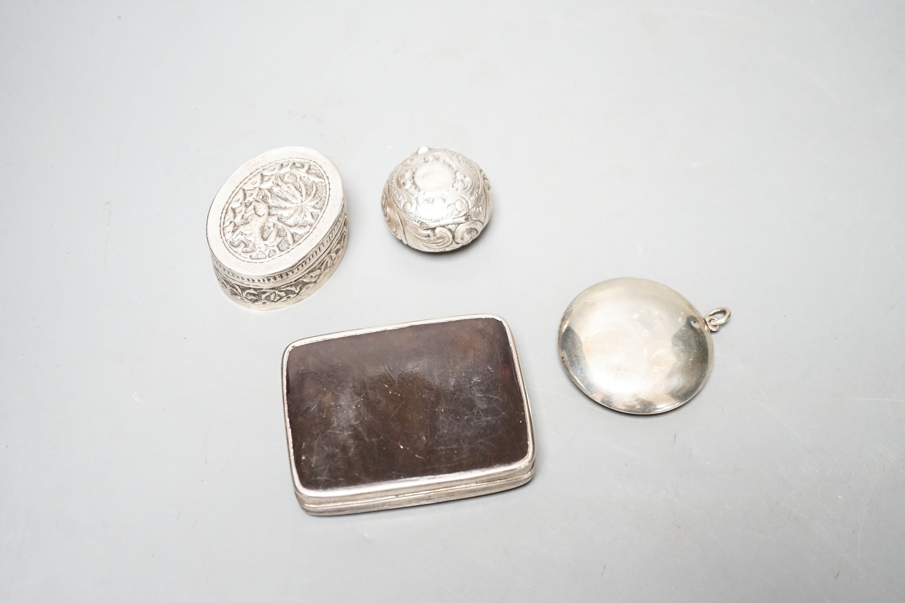 A selection of three small silver or white metal boxes to include a tortoiseshell pique box and a silver and shell inlaid compact.